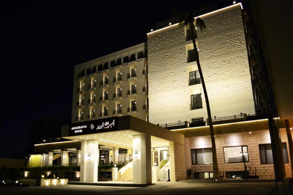 a large building with a sign on it at night at Ambassador, a Boutique Hotel in Amman