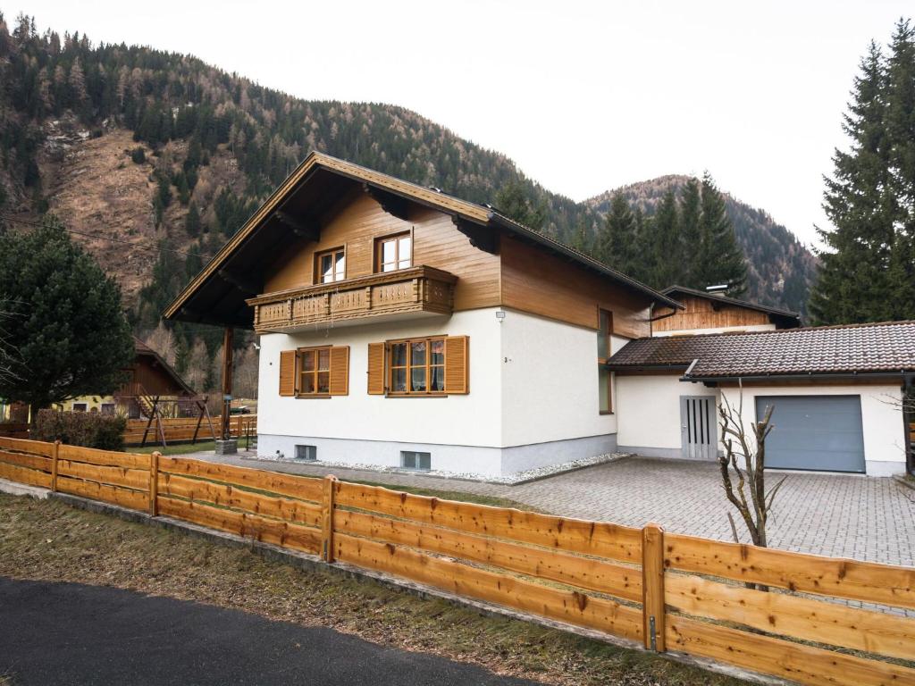 a house with a wooden fence in front of it at Large holiday home on the Katschberg in Carinthia in Rennweg