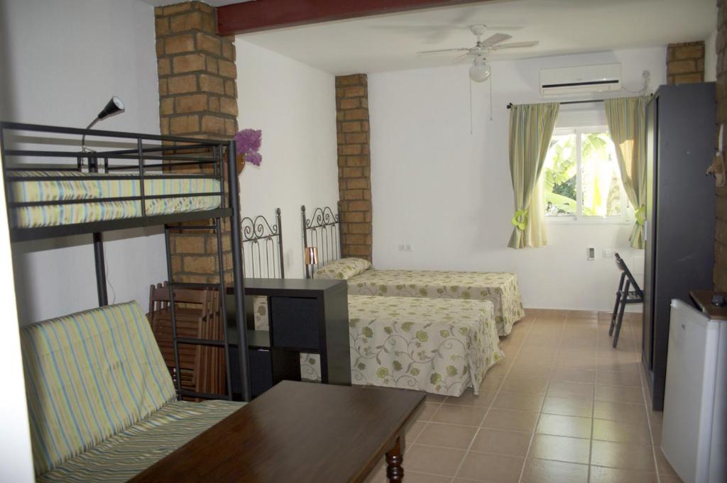 a living room with a bunk bed and a chair at Sevilla a tus pies in Mairena del Aljarafe