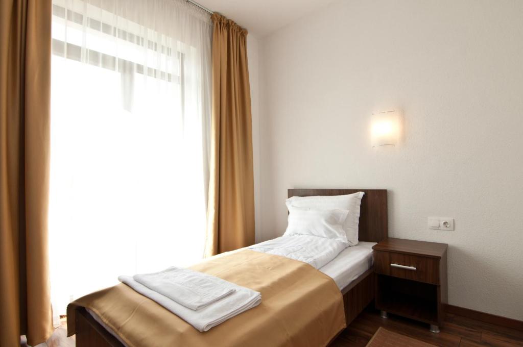 Postel nebo postele na pokoji v ubytování Hotel Hyperion