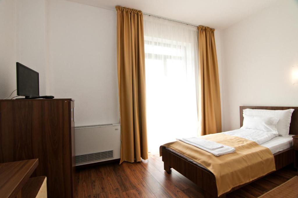 Postel nebo postele na pokoji v ubytování Hotel Hyperion