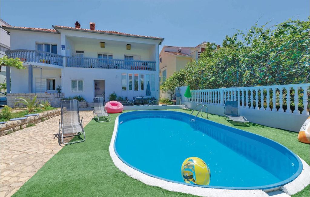 a swimming pool in the backyard of a house at Beautiful Apartment In Zadar With 2 Bedrooms, Wifi And Outdoor Swimming Pool in Zadar