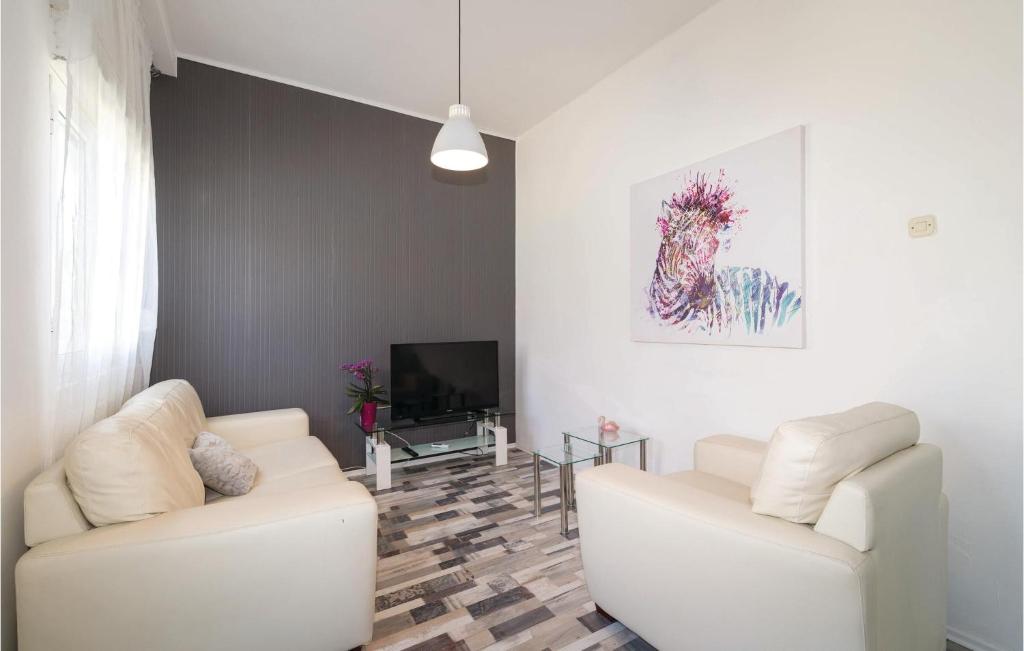 a living room with two white couches and a television at Awesome Apartment In Zadar With Wifi in Zadar