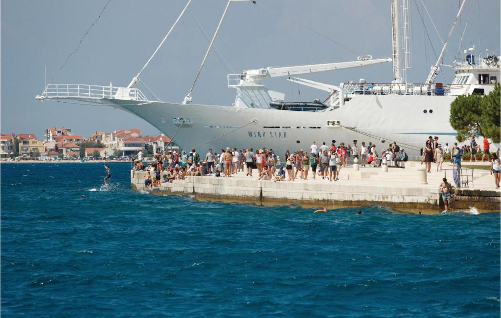 a group of people standing on a dock near a boat at Awesome Apartment In Zadar With Wifi in Zadar