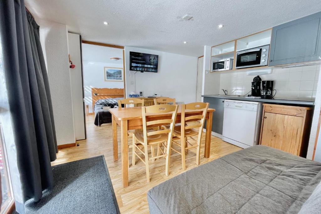 a kitchen and dining room with a table and chairs at The climber at Chamrousse #CU in Chamrousse