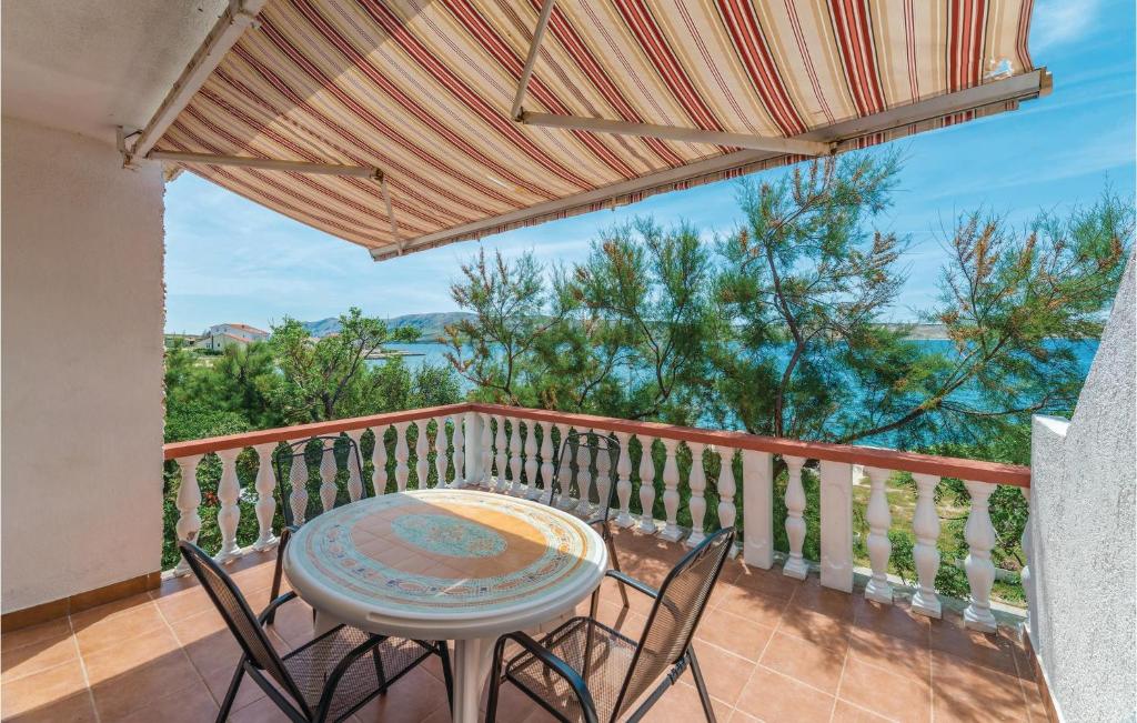 a patio with a table and chairs on a balcony at 2 Bedroom Lovely Apartment In Kustici in Kustići