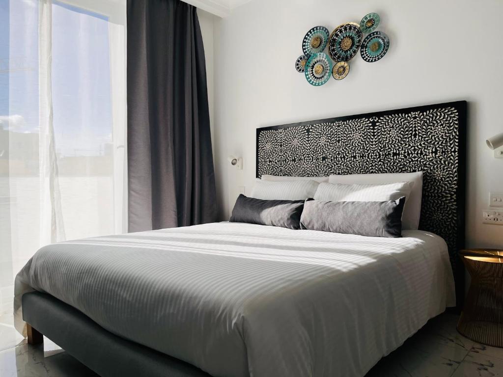 a bedroom with a large bed and a window at Apartments by Sliema promenade and beach in Sliema