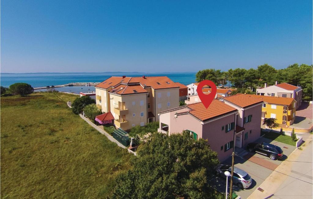 an aerial view of a house with the ocean in the background at Awesome Apartment In Privlaka With Kitchen in Batalaži