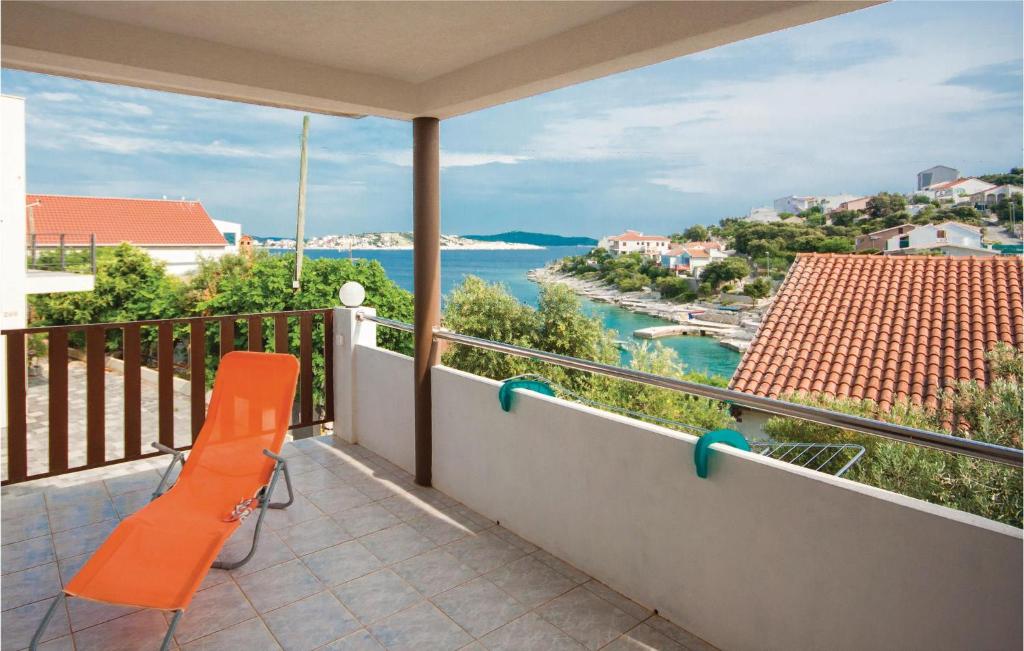 a balcony with a bench and a view of the water at Stunning Apartment In Kanica With House Sea View in Sevid