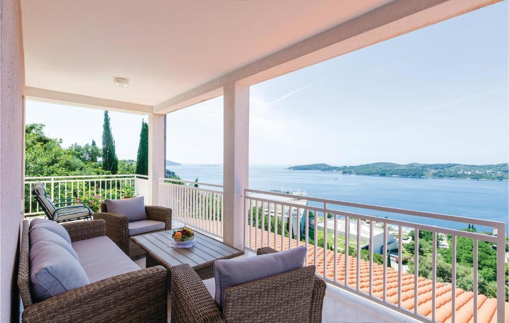 a balcony with chairs and a view of the water at 3 Bedroom Beautiful Apartment In Orasac in Orasac