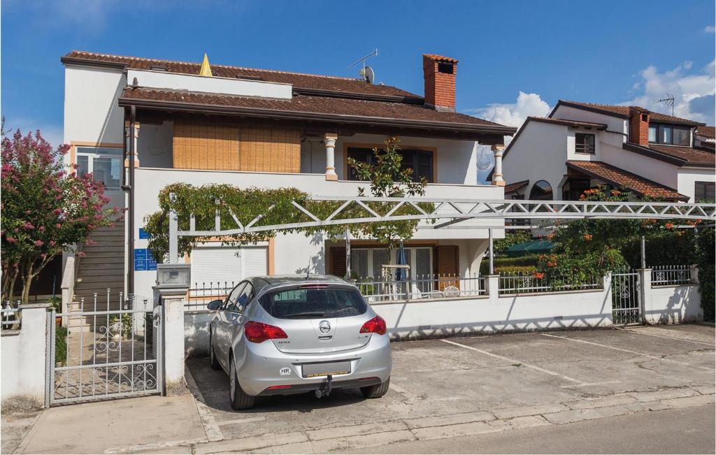 a silver car parked in front of a house at Awesome Apartment In Porec With 2 Bedrooms And Wifi in Poreč