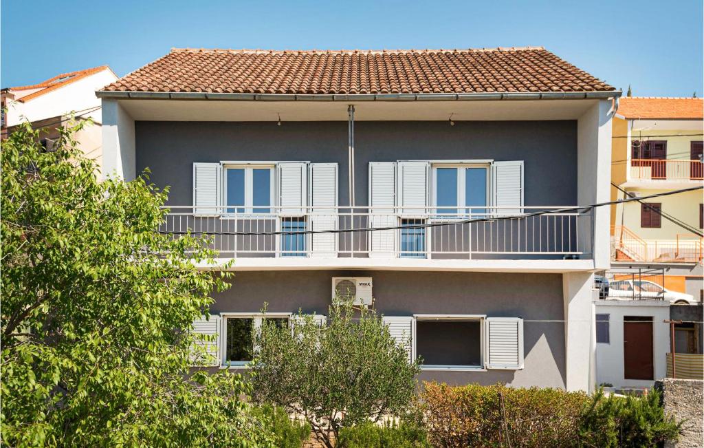 an apartment building with white windows and a balcony at 1 Bedroom Awesome Apartment In Sibenik in Šibenik