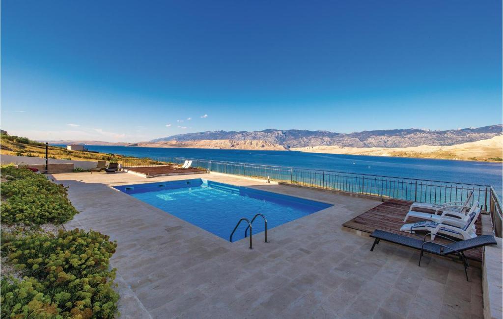 a swimming pool with a view of the water at Pet Friendly Apartment In Pag With Outdoor Swimming Pool in Pag