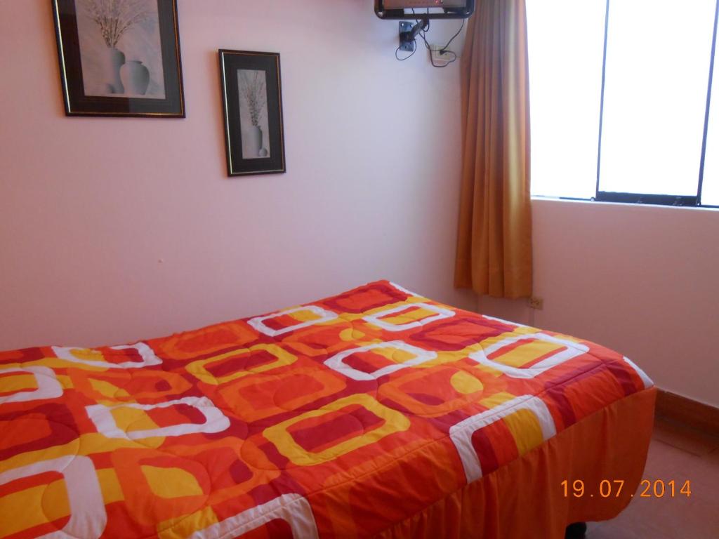 Postel nebo postele na pokoji v ubytování Hostal Cesar Alberto