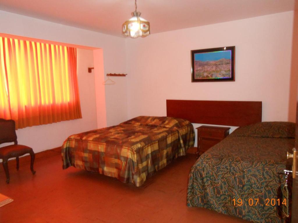 Postel nebo postele na pokoji v ubytování Hostal Cesar Alberto