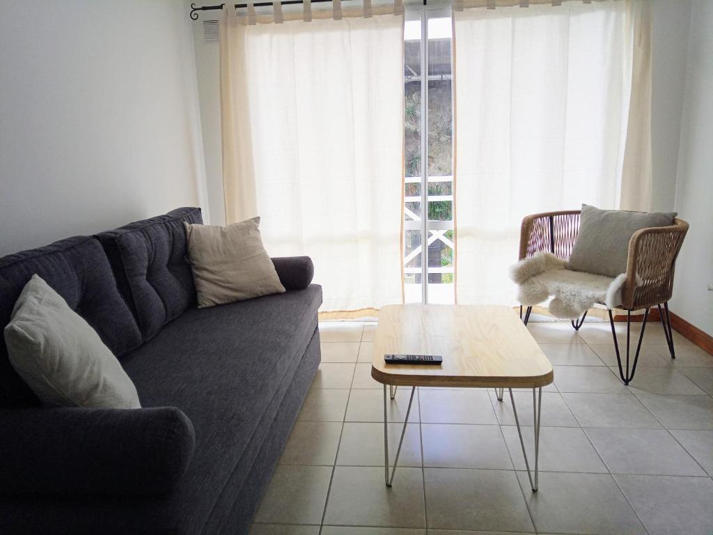 a living room with a couch and a coffee table at Main Street with a great Balcony in Ushuaia
