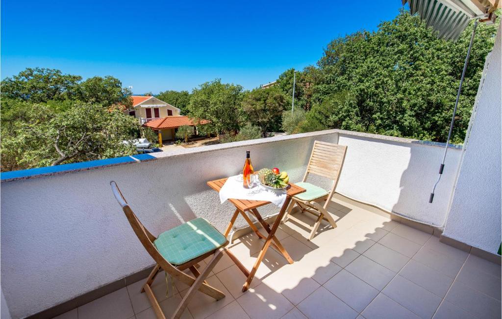 - un balcon avec deux chaises et une table avec une bouteille de vin dans l'établissement Beautiful Apartment In Potocnica With Wifi, à Borovići