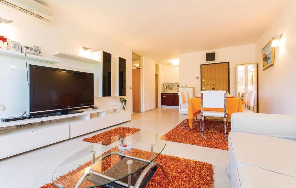 a living room with a large flat screen tv at Amazing Apartment In Njivice With Wifi in Njivice
