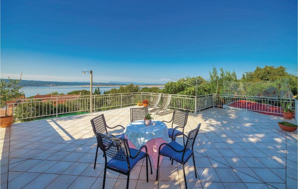 a patio with a table and chairs on a balcony at Nice Home In Dramalj With Wifi in Dramalj