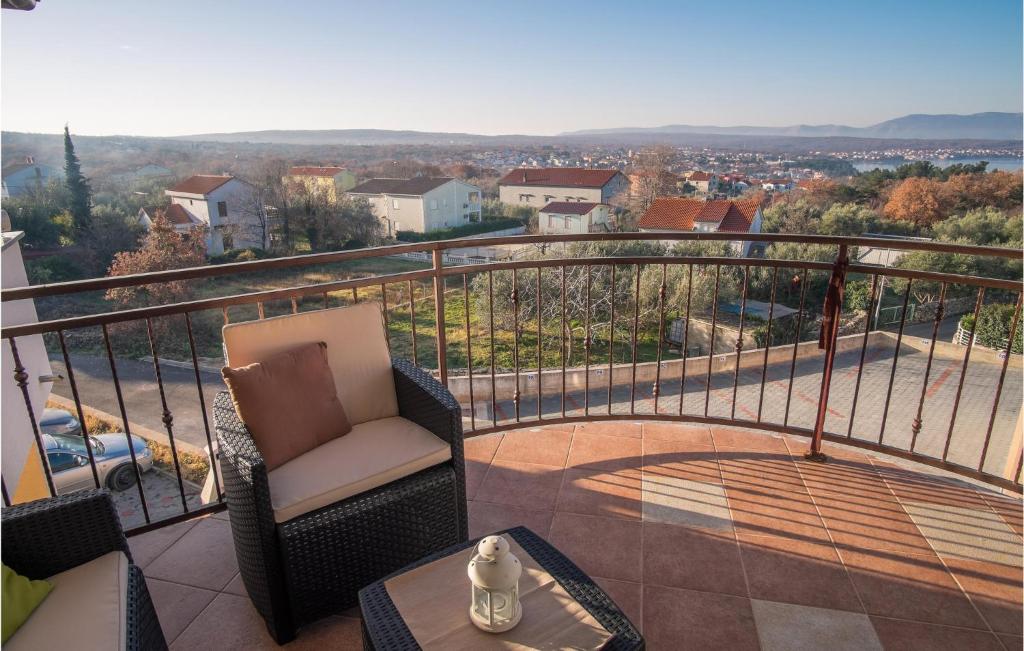 a balcony with a chair and a table at Lovely Apartment In Sveti Vid Miholjice With House Sea View in Sveti Vid-Miholjice