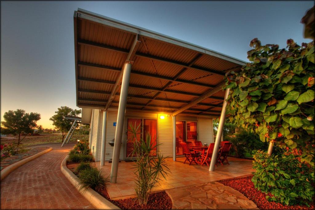 una casa con una veranda coperta con un edificio di Samson Beach Chalets a Point Samson