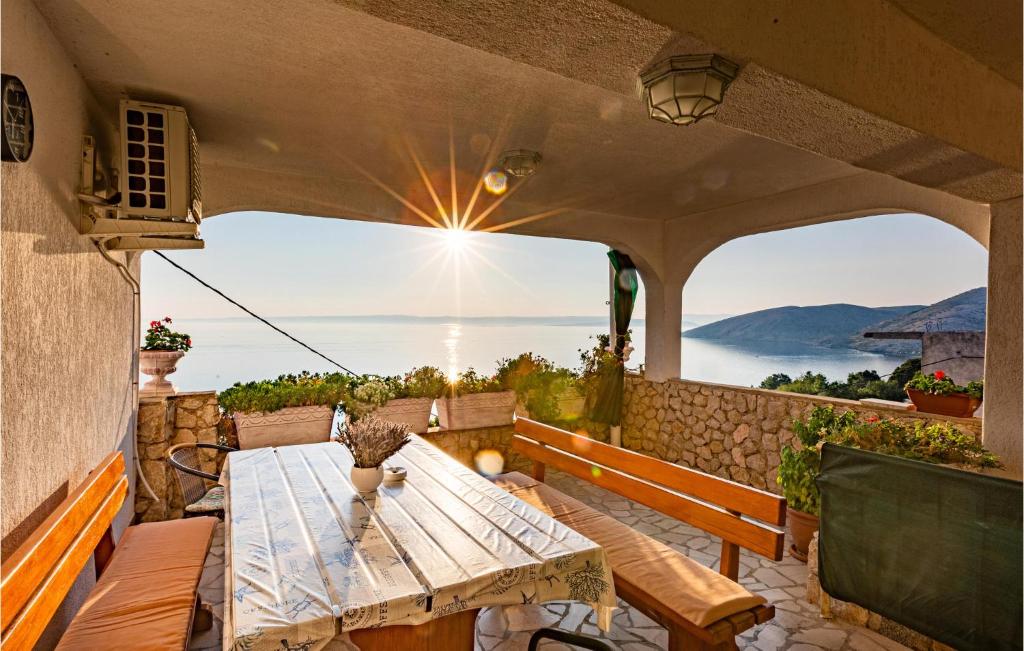 a patio with a table and a view of the ocean at 2 Bedroom Nice Apartment In Stara Baska in Stara Baška