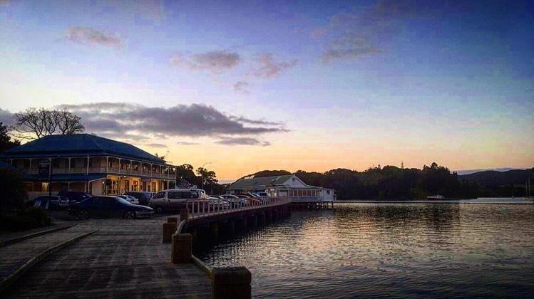 boats are docked at a dock in the water at Mangonui Hotel in Mangonui