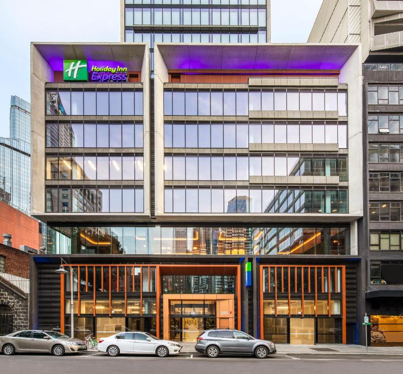 a building with cars parked in front of it at Holiday Inn Express Melbourne Little Collins, an IHG Hotel in Melbourne