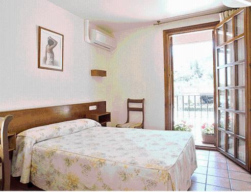 Postel nebo postele na pokoji v ubytování Hostal Lorentxo