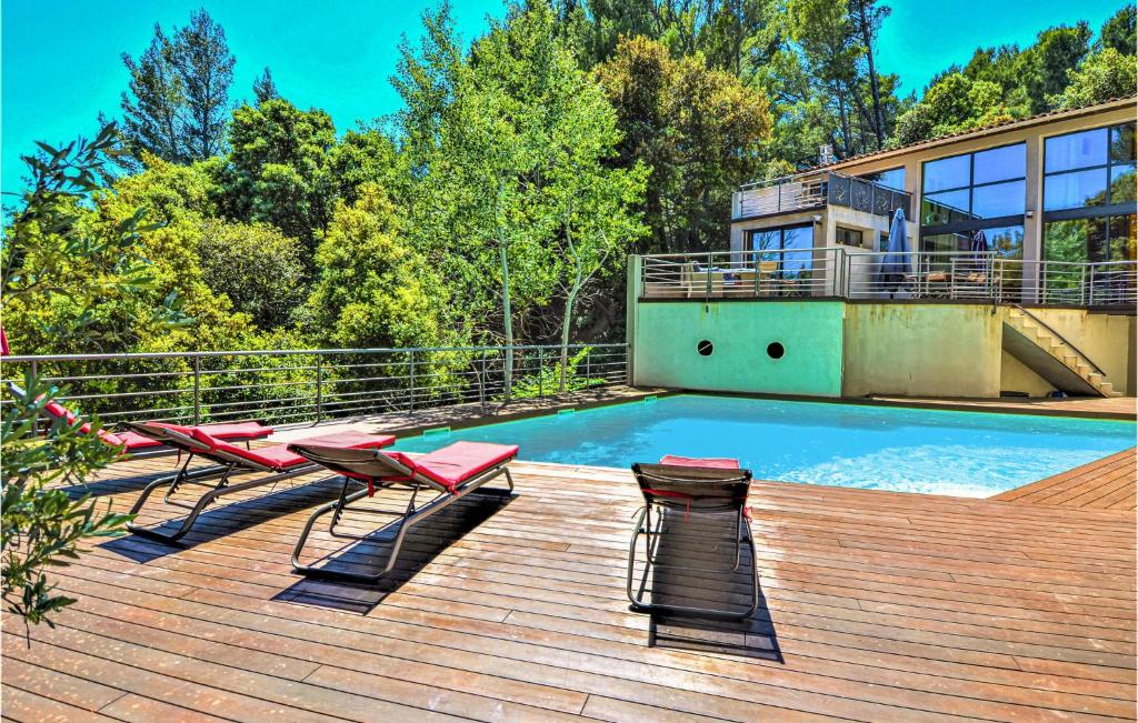 a deck with chairs and a swimming pool at Amazing Home In Sauveterre With Wifi in Sauveterre