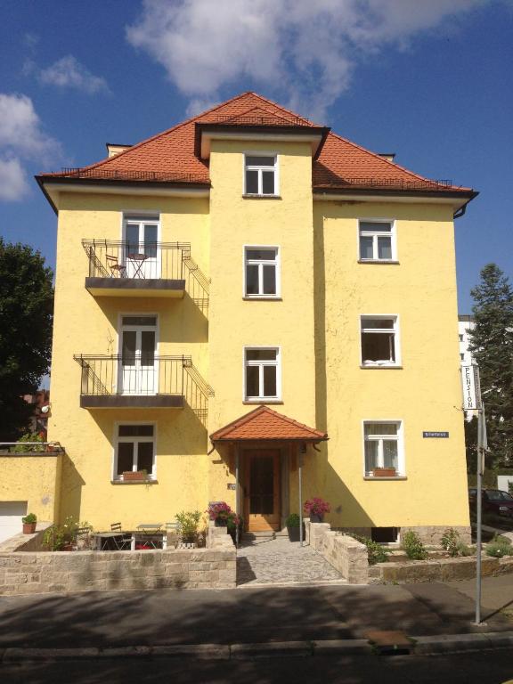 a large yellow building with a red roof at Sanderau NA29 in Würzburg