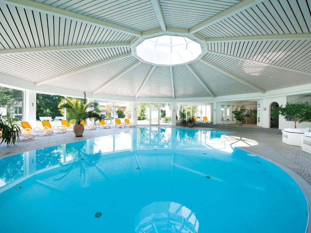 a large swimming pool with a ceiling at Hotel Traube Revital in Wurmlingen