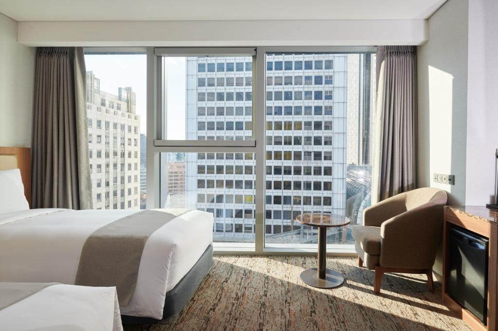 Postel nebo postele na pokoji v ubytování Stanford Hotel Myeongdong