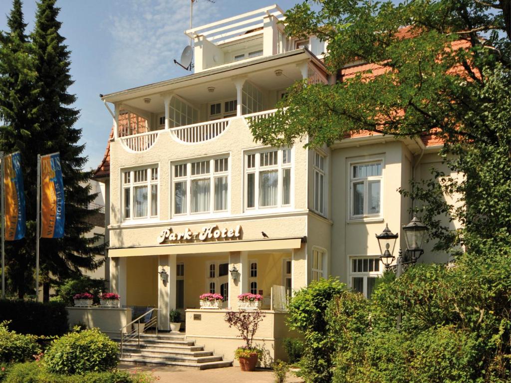 a large white building with a balcony at Park-Hotel in Timmendorfer Strand