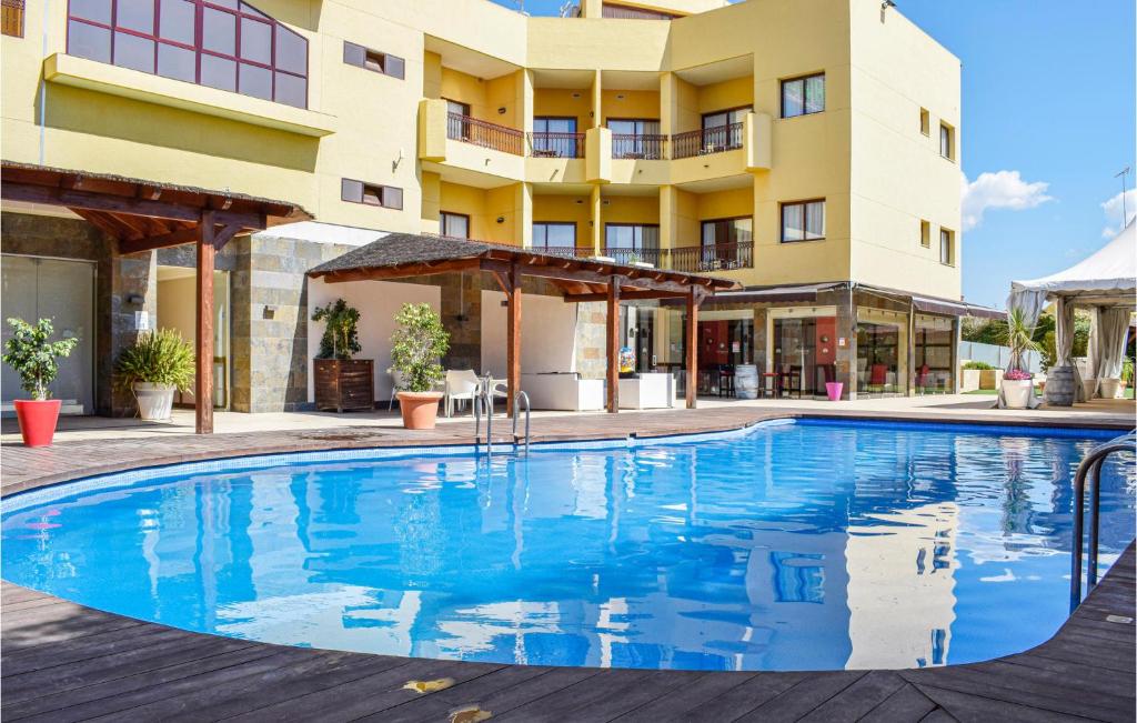 a swimming pool in front of a building at Lovely Apartment In Mazarrn With Outdoor Swimming Pool in Bolnuevo