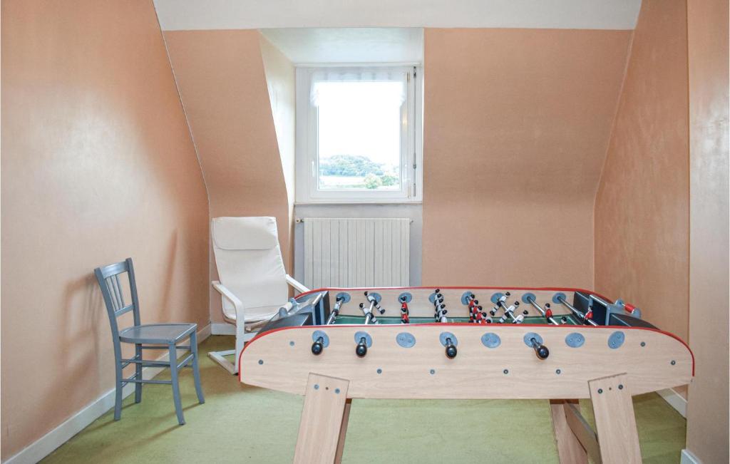 a room with a ping pong table and two chairs at Stunning Home In Kerbors With House Sea View in Kerbors