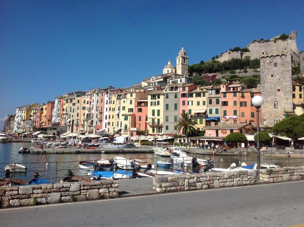 a group of boats in a harbor with buildings at Affittacamere La Lanterna in Portovenere