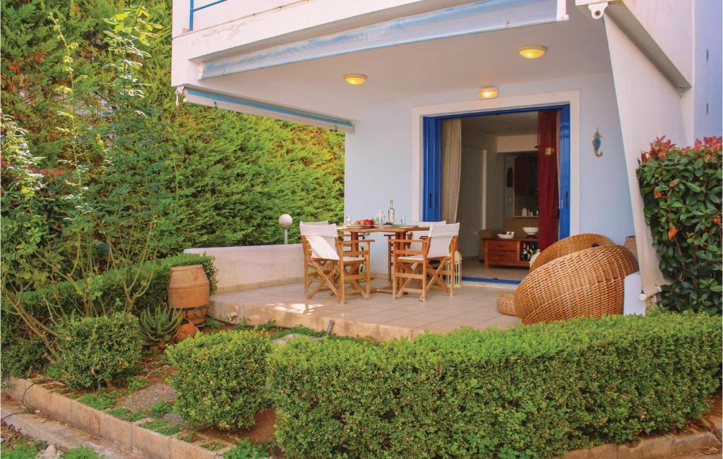 a patio with a table and chairs on it at Awesome Apartment In Melissi Korinthia in Dhiminión