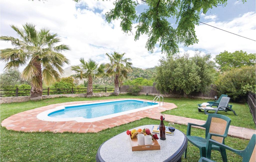 a backyard with a pool and a table with fruit on it at Beautiful Home In Zahara De La Sierra in Zahara de la Sierra