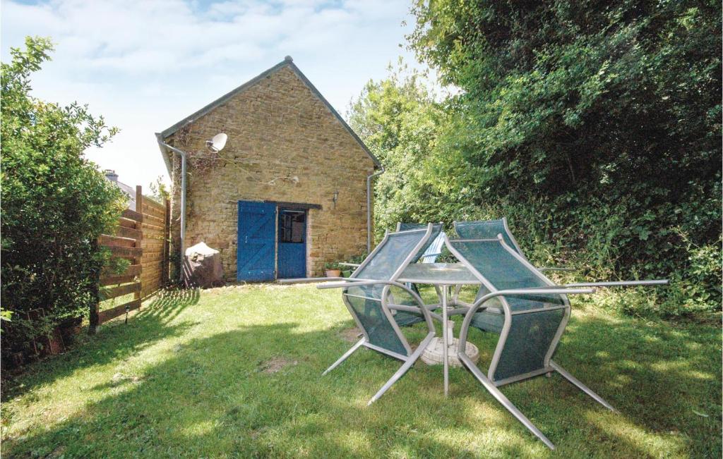 a table and chairs in a yard with a building at Beautiful Home In Le Faout With Kitchen in Le Faouët