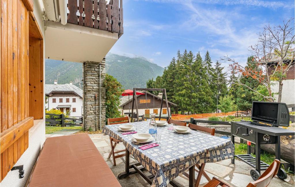 a patio with a table and chairs on a balcony at Cozy Apartment In Ayas With Kitchenette in Champoluc