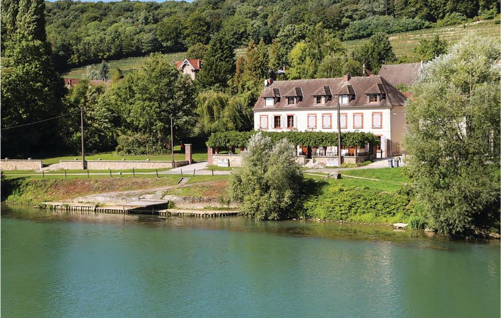 a large house next to a river with a house at 3 Bedroom Awesome Home In Jaulgonne in Jaulgonne