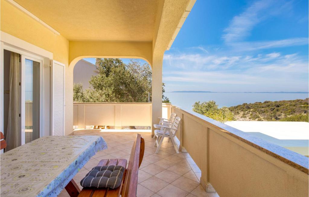 a balcony with a table and a view of the ocean at 2 Bedroom Nice Apartment In Potocnica in Potocnica