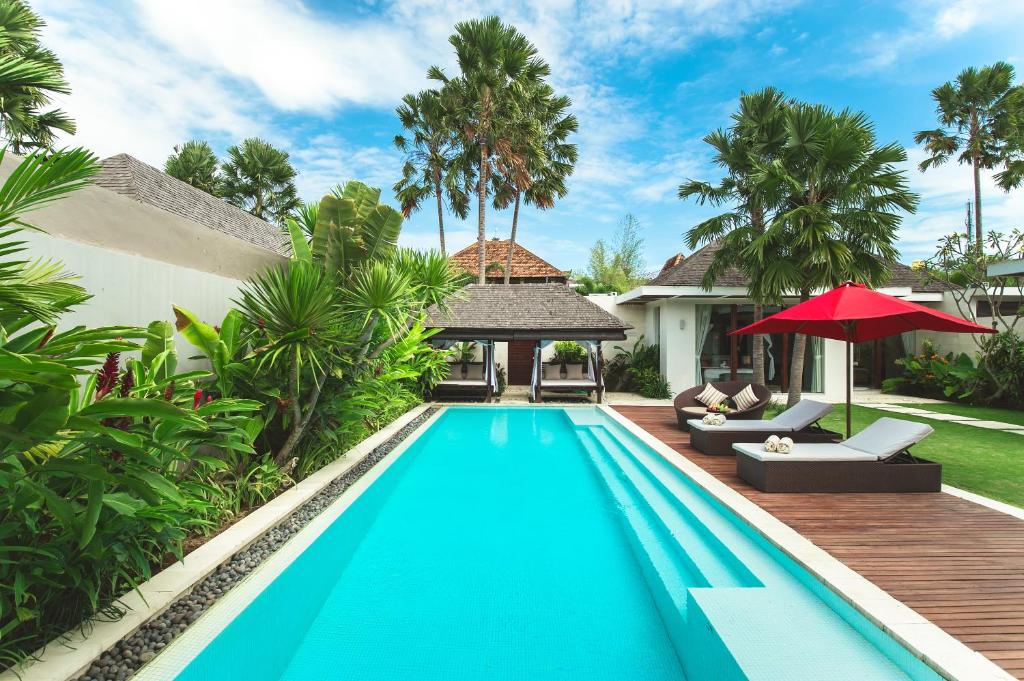 a swimming pool in the backyard of a villa at Chandra Bali Villas in Seminyak