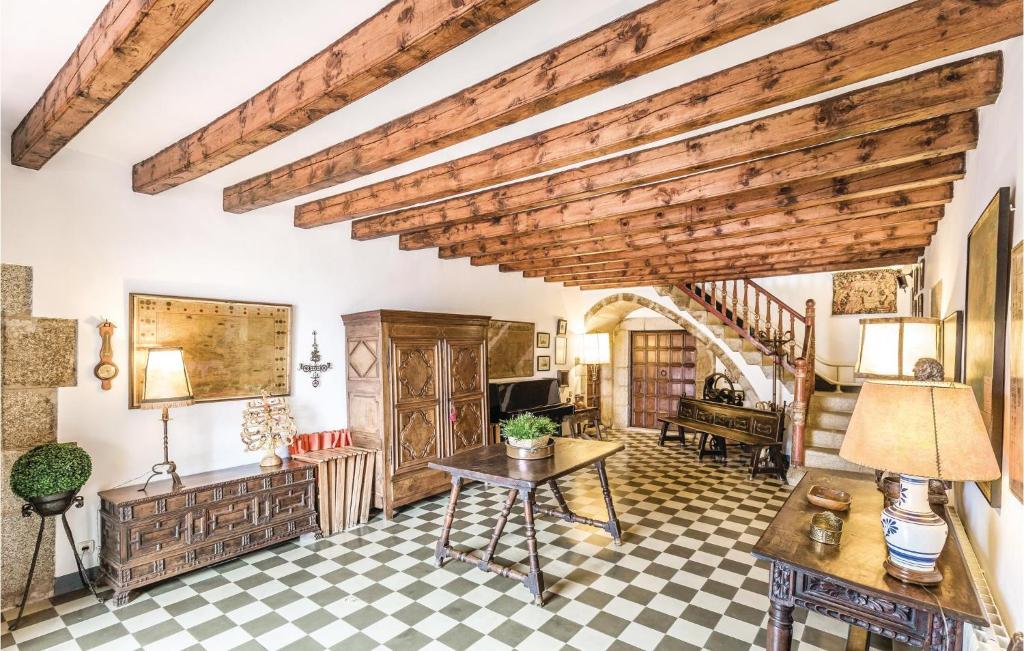 a living room with a wooden ceiling and checkered floor at Beautiful Home In Arenys De Munt With 6 Bedrooms, Private Swimming Pool And Outdoor Swimming Pool in Arenys de Munt