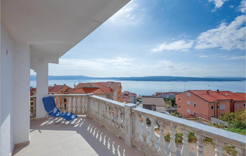 a balcony with a chair and a view of the water at Stunning Apartment In Crikvenica With Wifi in Crikvenica
