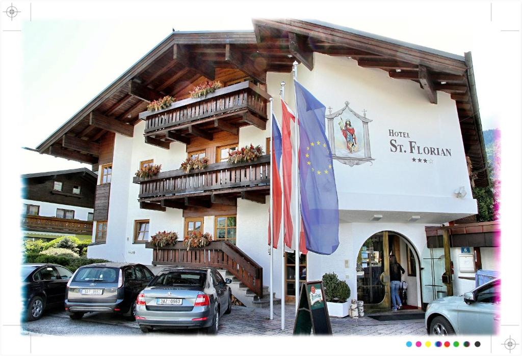a building with cars parked in front of it at Hotel St. Florian - Kaprun in Kaprun