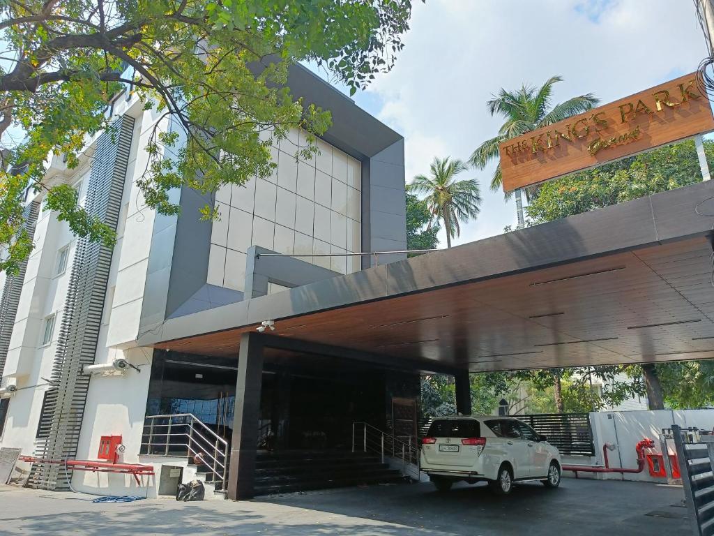 a white truck parked in front of a building at The Kings Park Grand-Near US Consulate in Chennai