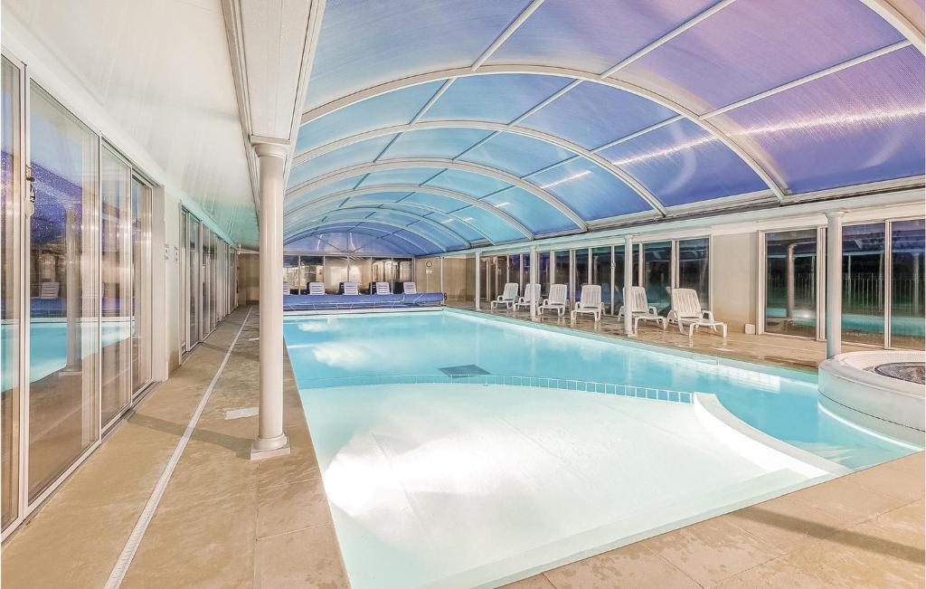 a large swimming pool with a glass ceiling at Le Hameau De Peemor Pen in Morgat