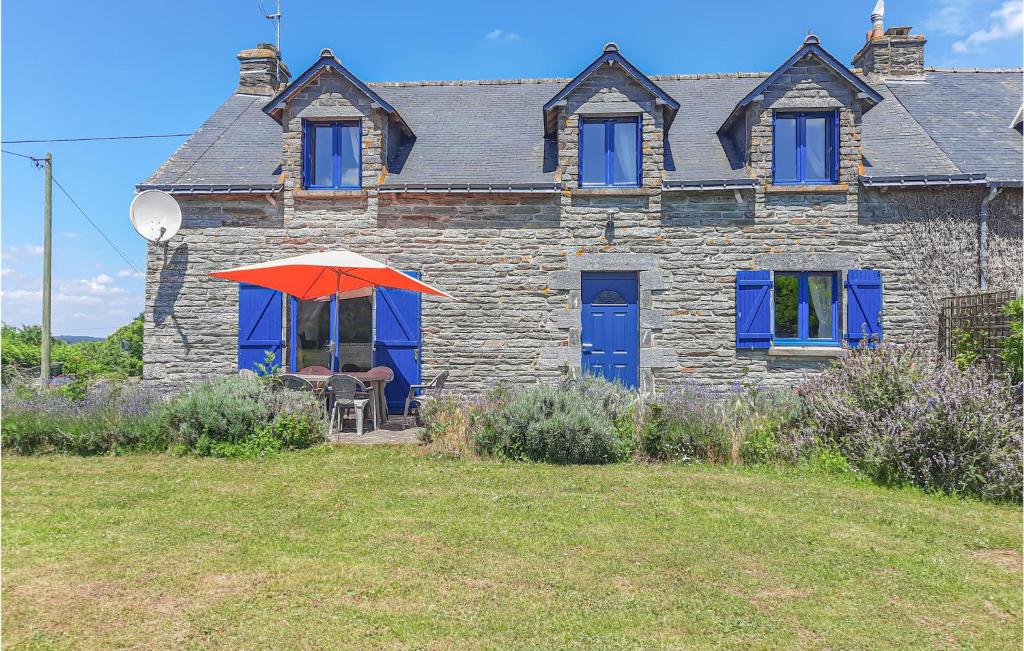 a house with a red umbrella in front of it at 3 Bedroom Lovely Home In Ruffiac in Ruffiac